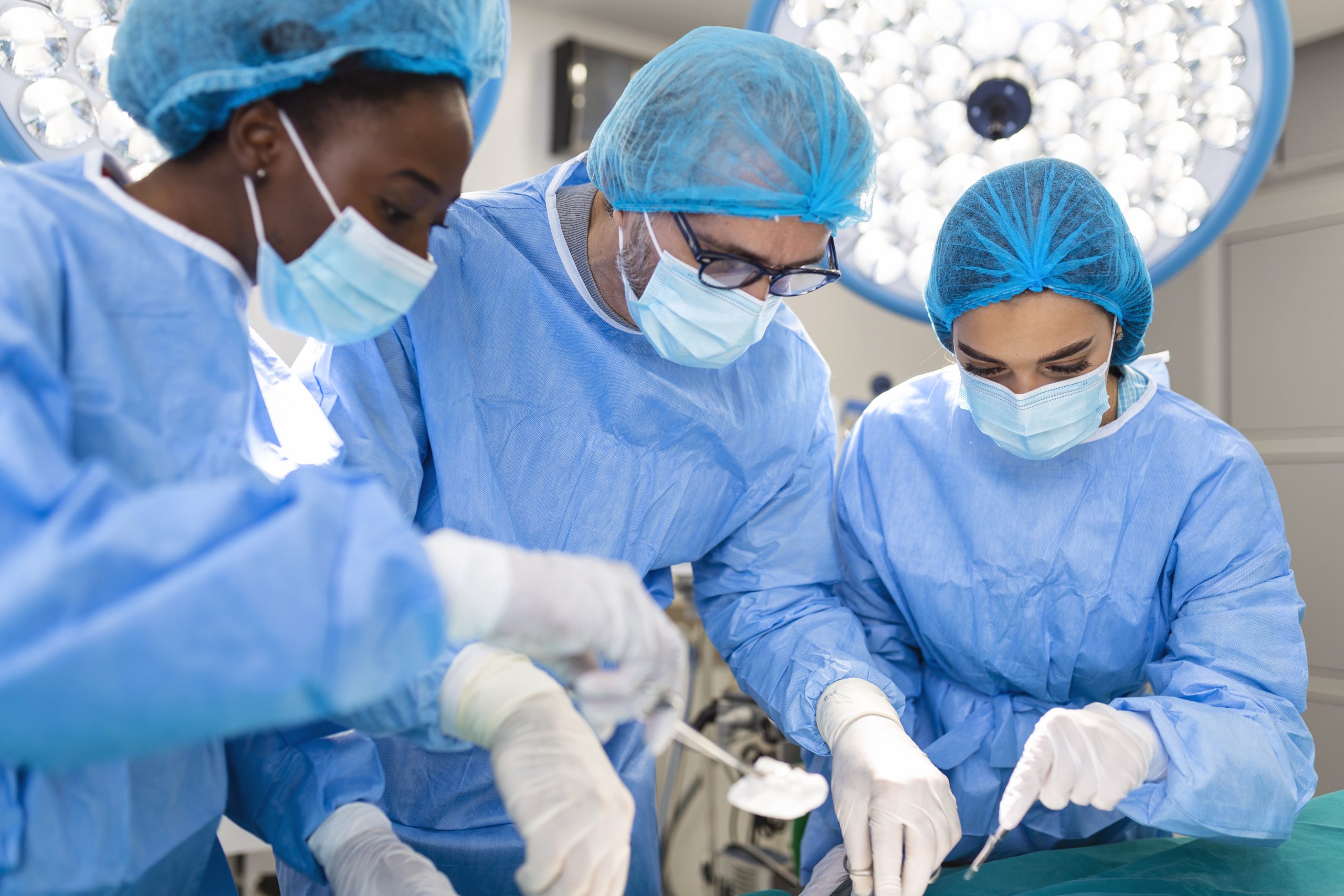 Surgeon team in uniform performs an operation on a patient at a cardiac surgery clinic. Modern medicine, a professional team of surgeons, health.